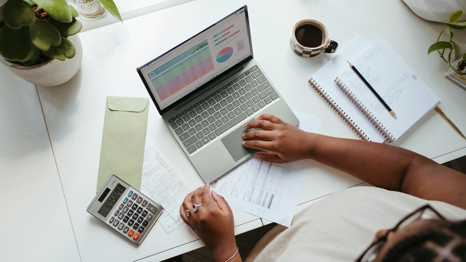 a person sitting at a table with a laptop